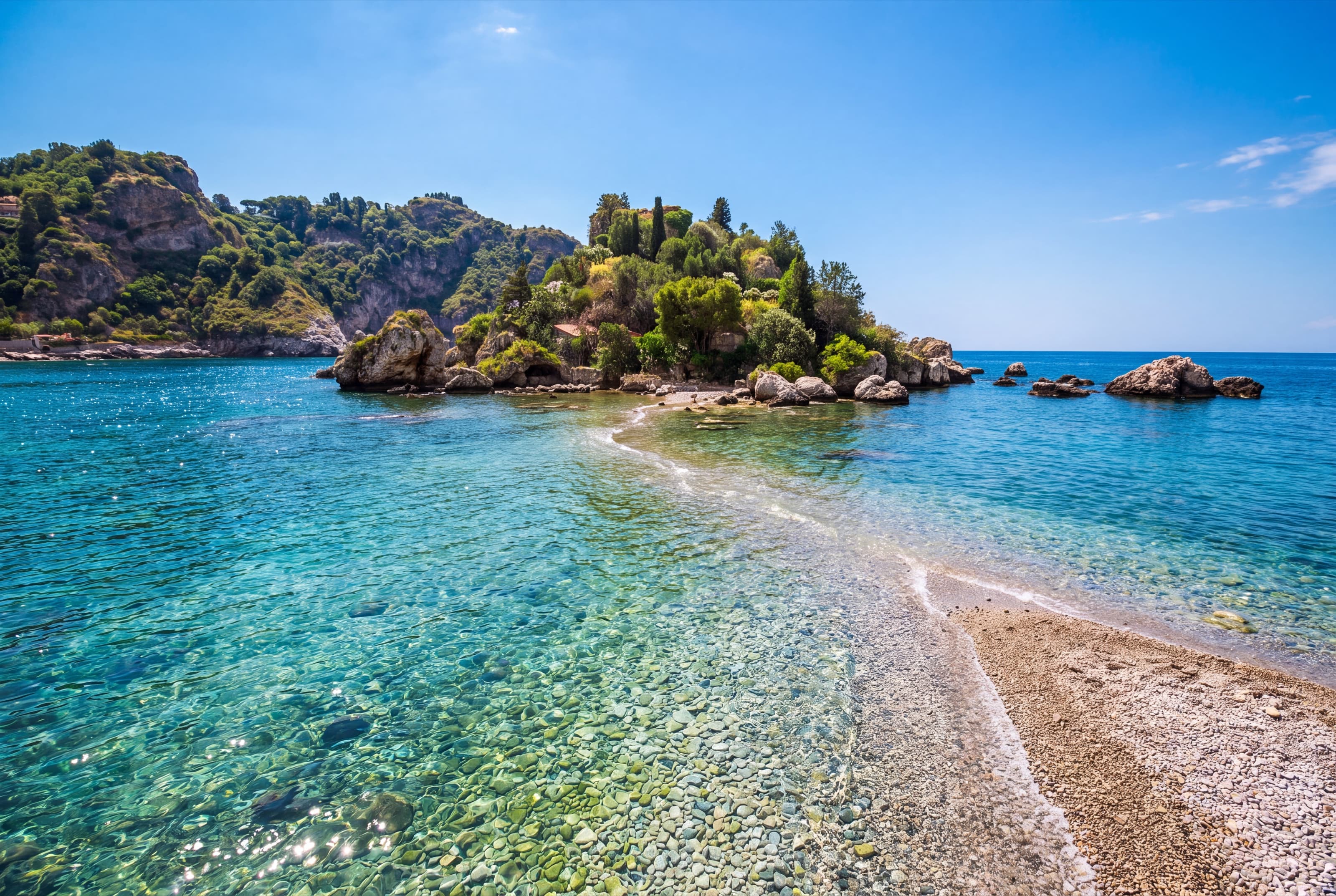 The pebble strip joining Isola Bella to the shore, with clear turquoise water