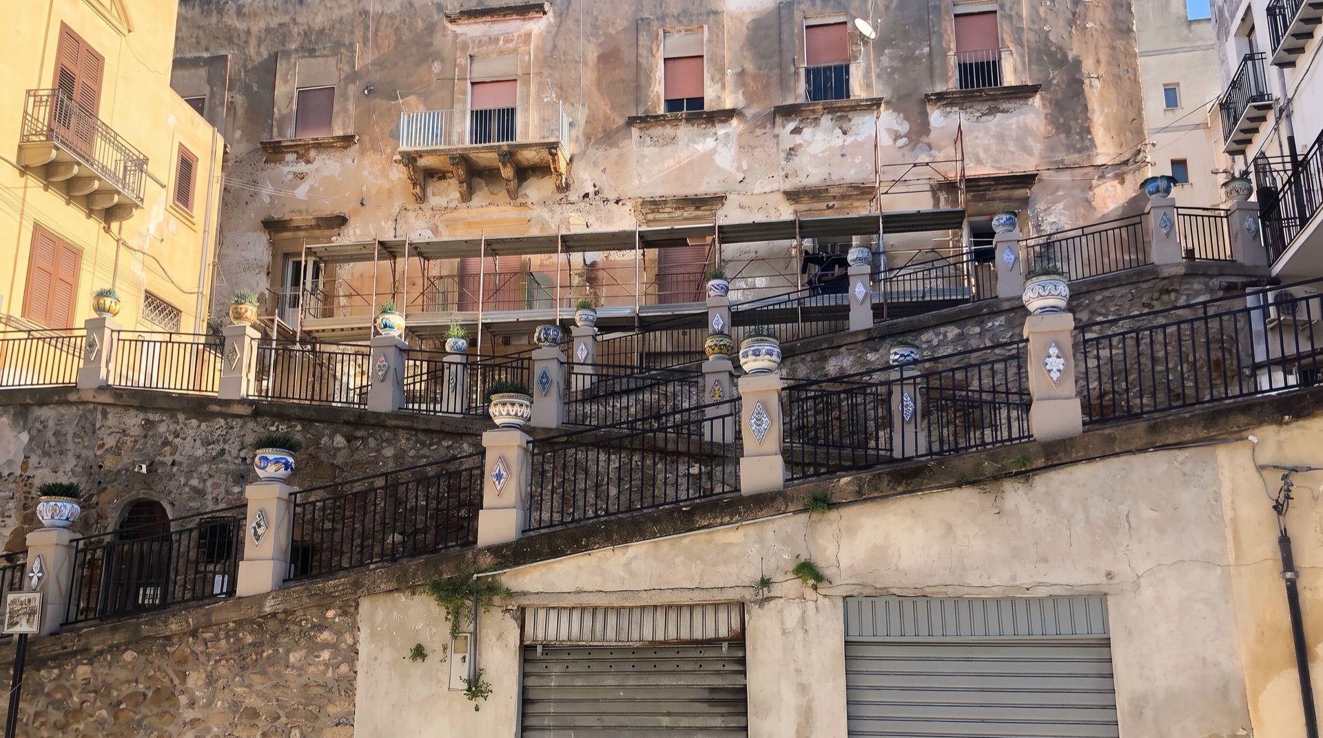 Ceramic-tiled steps climbing between the streets of a Sicilian old town