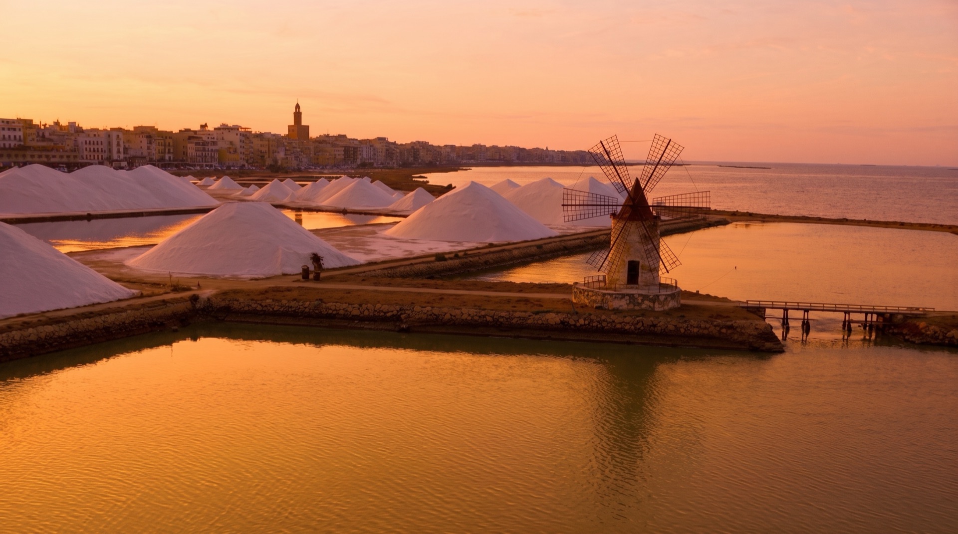 The salt pans between Birgi airport and Trapani at sunset, the flat coastal landscape the road into the city crosses