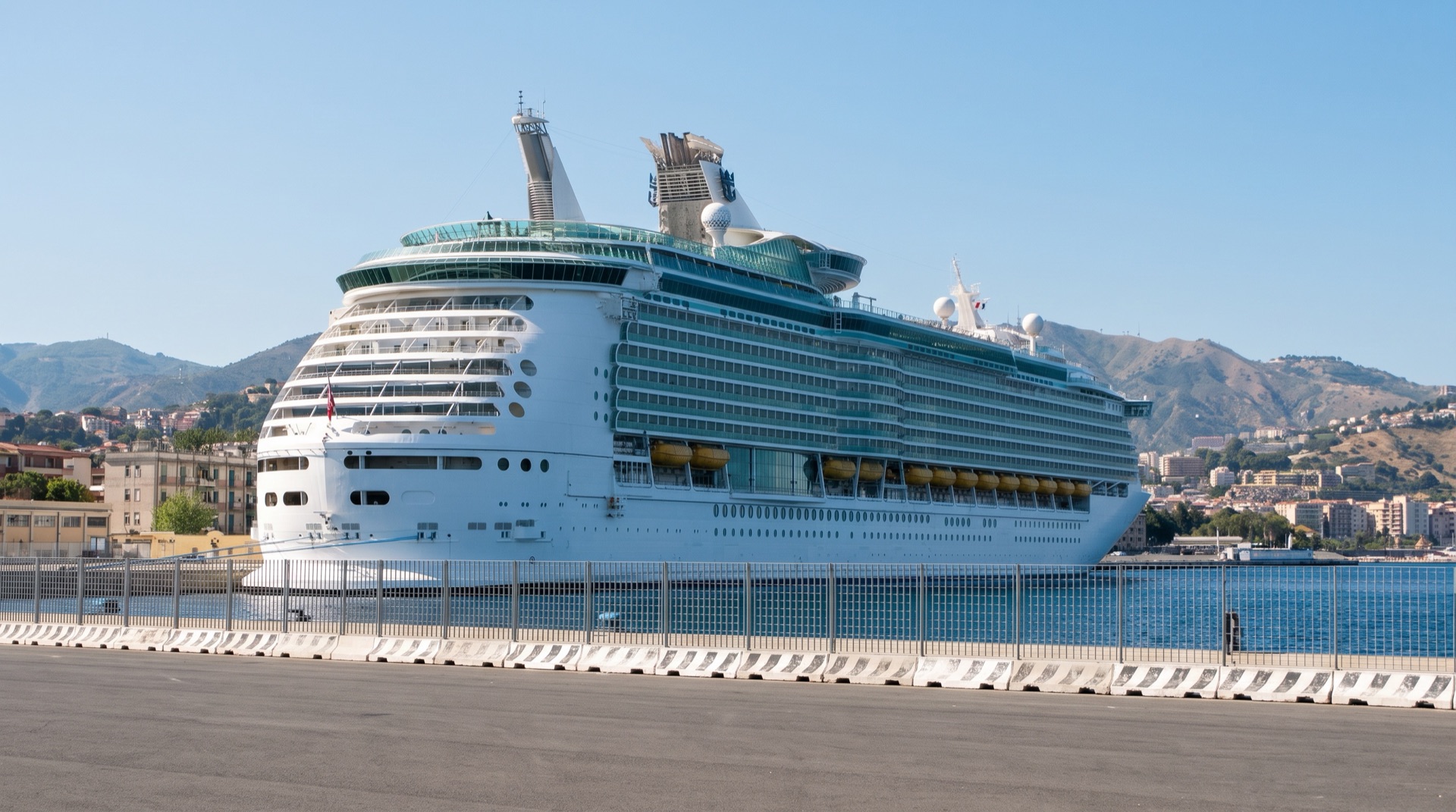 Cruise ship berthed at the Messina port quays on the city side, with the Via Vittorio Emanuele II waterfront a short walk from the gangway