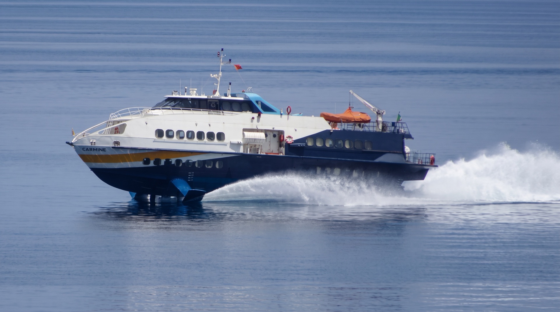 White wake of a hydrofoil crossing the Tyrrhenian Sea from the Aeolian Islands towards the port of Milazzo